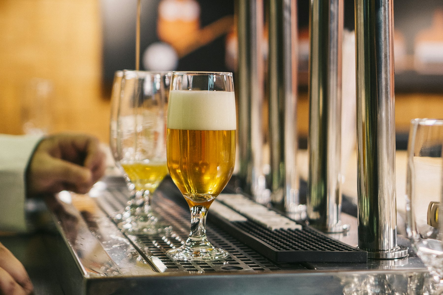 Fresh pints lined up on the tap tray at the bar
