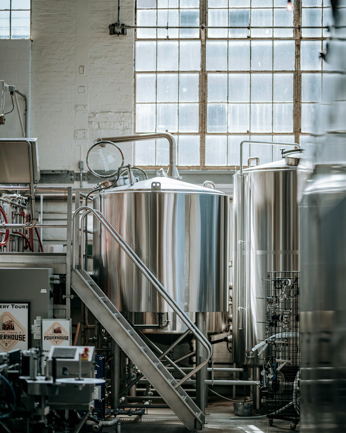 The steel brewhouse under the unit's factory window